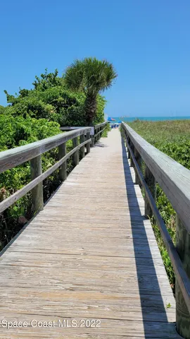 a view of balcony with wooden floor and fence