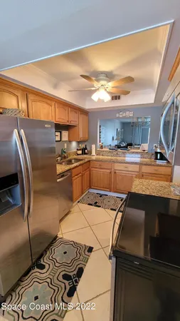 a kitchen with stainless steel appliances granite countertop a sink refrigerator and microwave