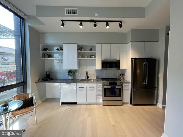 a kitchen with stainless steel appliances granite countertop a stove and a refrigerator