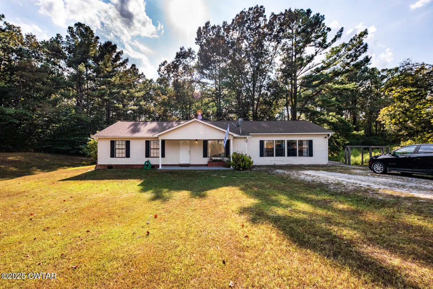 a front view of a house with yard and swimming pool
