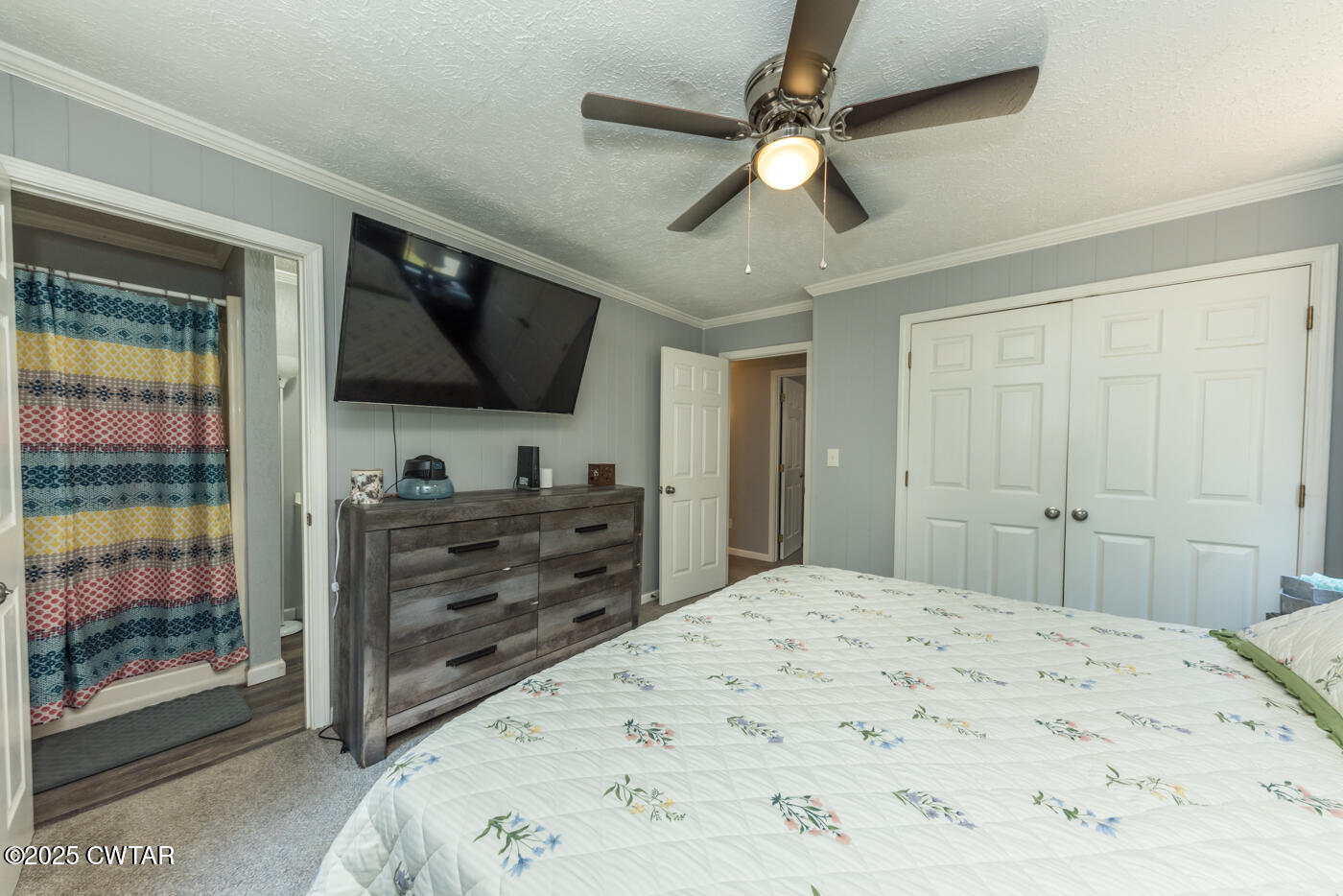 1840 Blue Goose Road Huron, TN 38345 - Photo 11 of 35 a bedroom with a bed and a flat screen tv