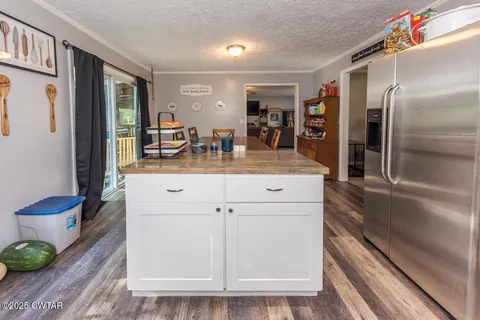a kitchen with kitchen island wooden cabinets and white appliances
