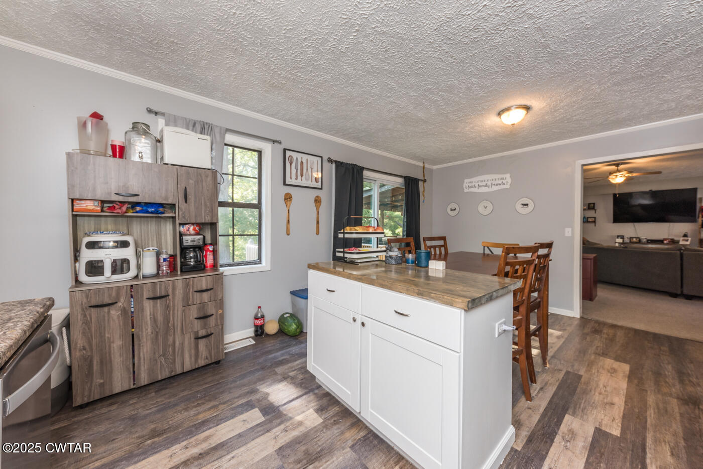 1840 Blue Goose Road Huron, TN 38345 - Photo 16 of 35 a kitchen with kitchen island wooden cabinets and white appliances