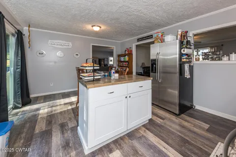a bedroom with a large bed and a chandelier fan