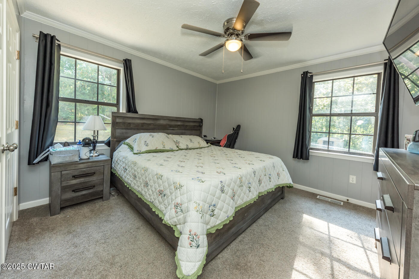 1840 Blue Goose Road Huron, TN 38345 - Photo 19 of 35 a bedroom with a large bed and a chandelier fan