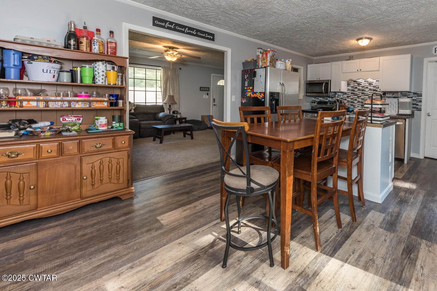 1840 Blue Goose Road Huron, TN 38345 - Photo 6 of 35 a kitchen with stainless steel appliances kitchen island granite countertop a table and chairs in it