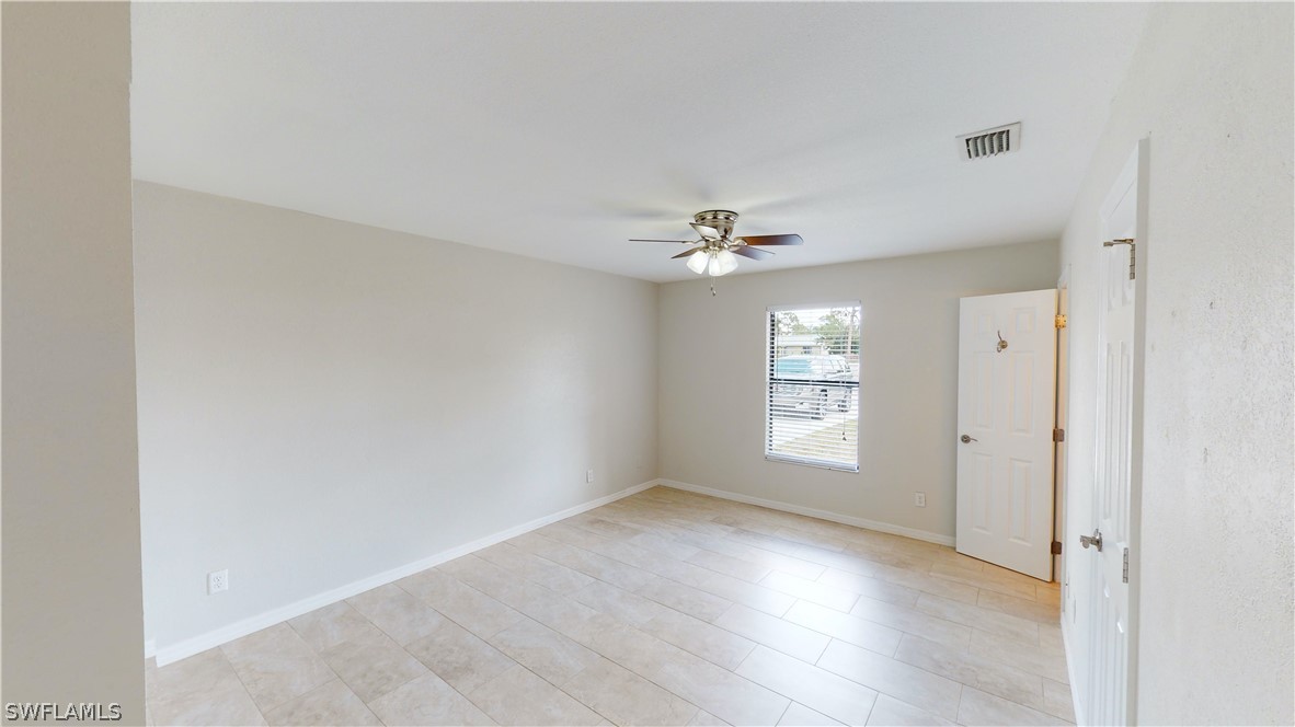 19154 Birch Road Fort Myers, FL 33967 - Photo 12 of 24 a view of an empty room with a window and wooden floor
