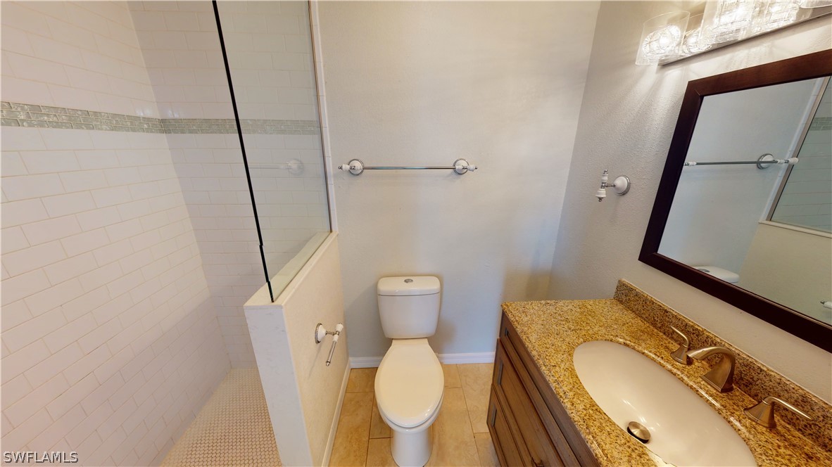 19154 Birch Road Fort Myers, FL 33967 - Photo 14 of 24 a bathroom with a granite countertop toilet and a sink