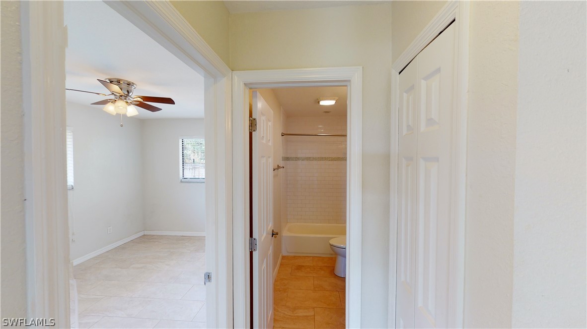 19154 Birch Road Fort Myers, FL 33967 - Photo 16 of 24 a bathroom with a glass shower door