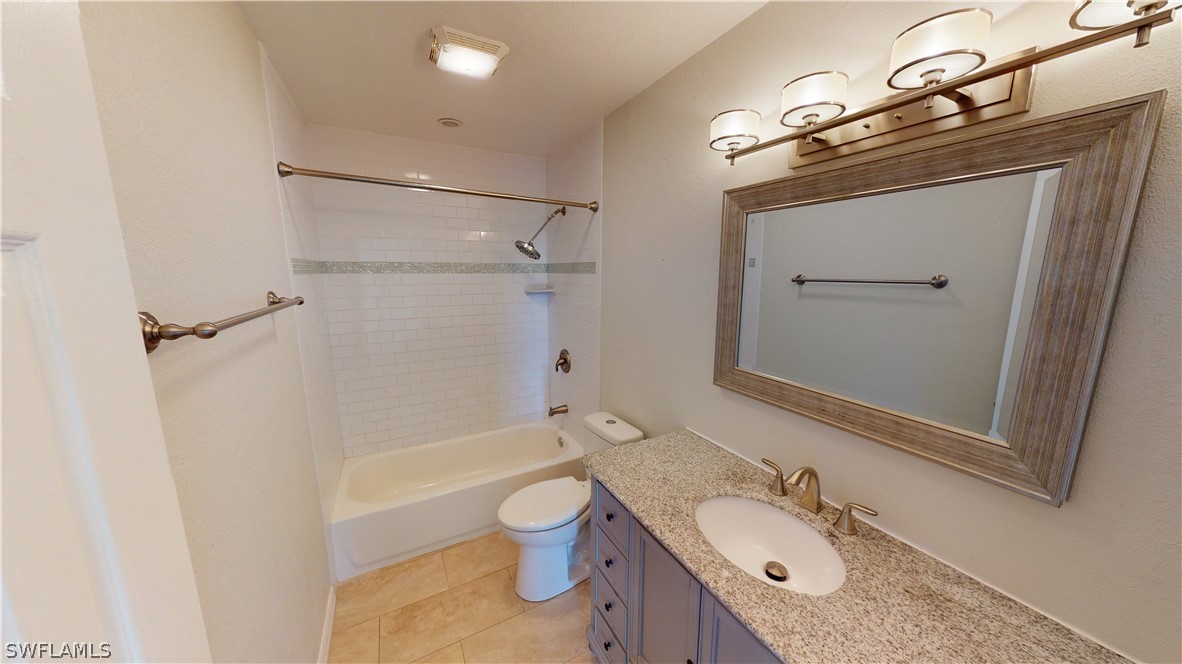 19154 Birch Road Fort Myers, FL 33967 - Photo 17 of 24 a bathroom with a granite countertop sink toilet and shower