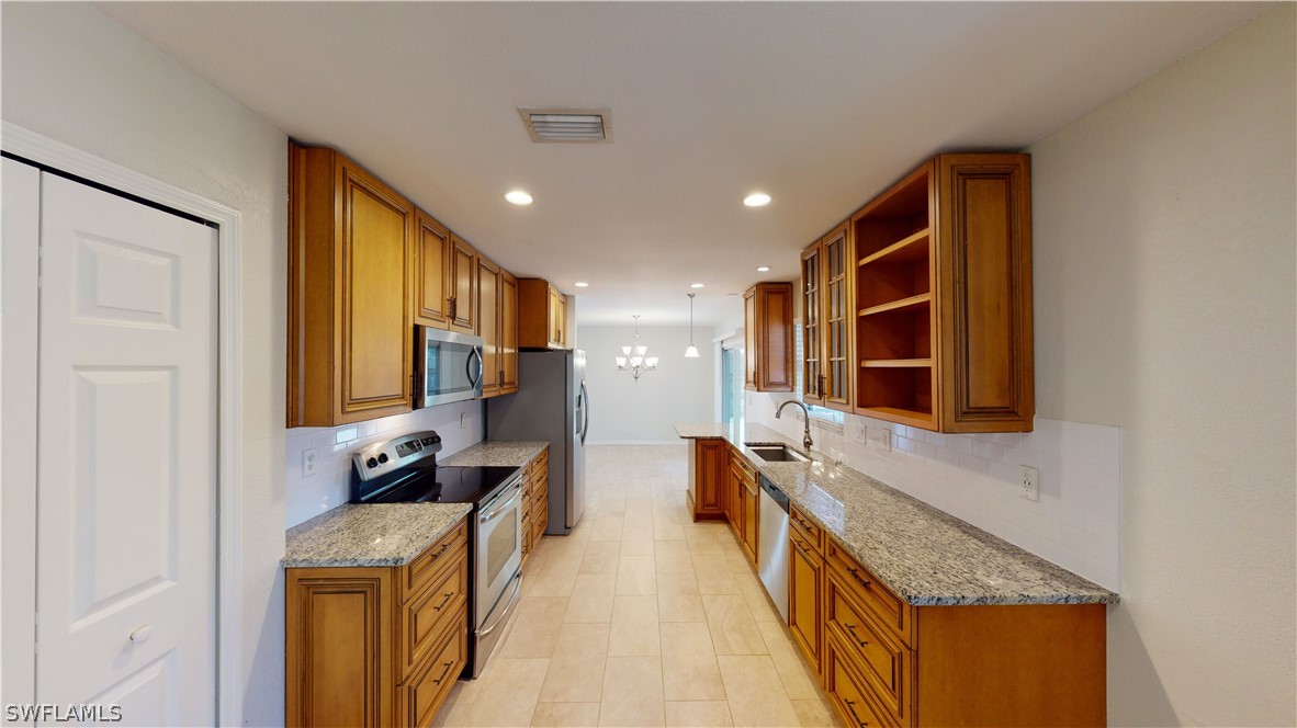 19154 Birch Road Fort Myers, FL 33967 - Photo 2 of 24 a hallway with stainless steel appliances granite countertop lots of counter top space