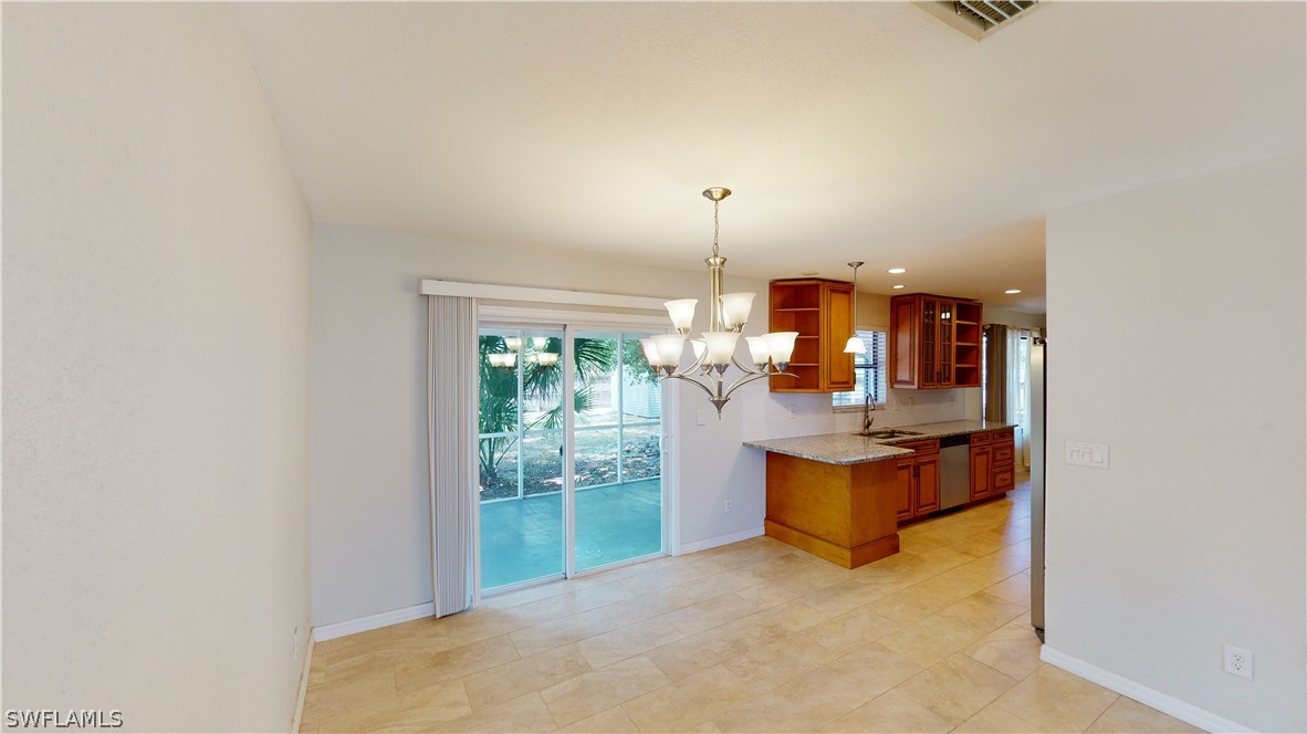 19154 Birch Road Fort Myers, FL 33967 - Photo 6 of 24 an empty room with floor to ceiling window and potted plants