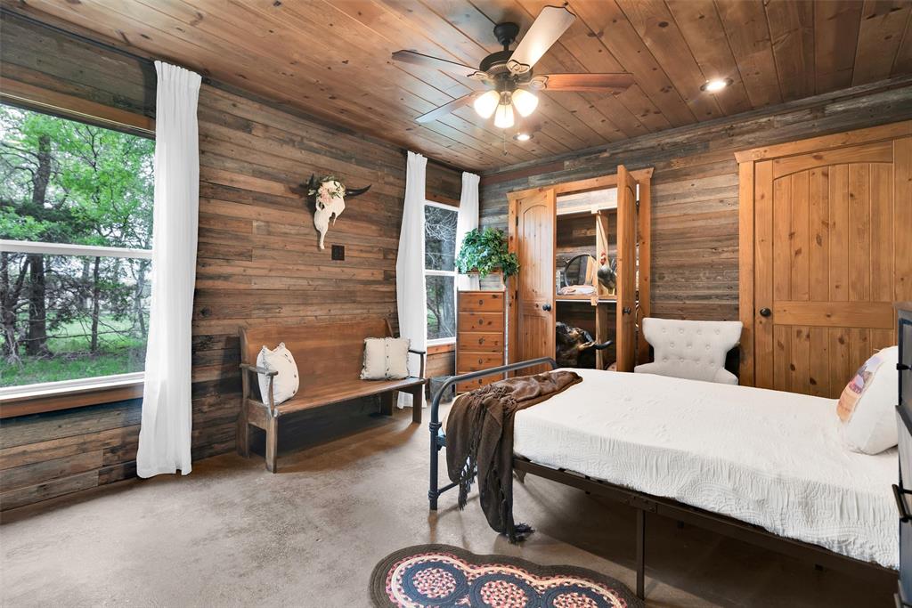 8665 Cr-669 Blue Ridge Blue Ridge, TX 75424 - Photo 31 of 40 a bedroom with a bed and a chandelier