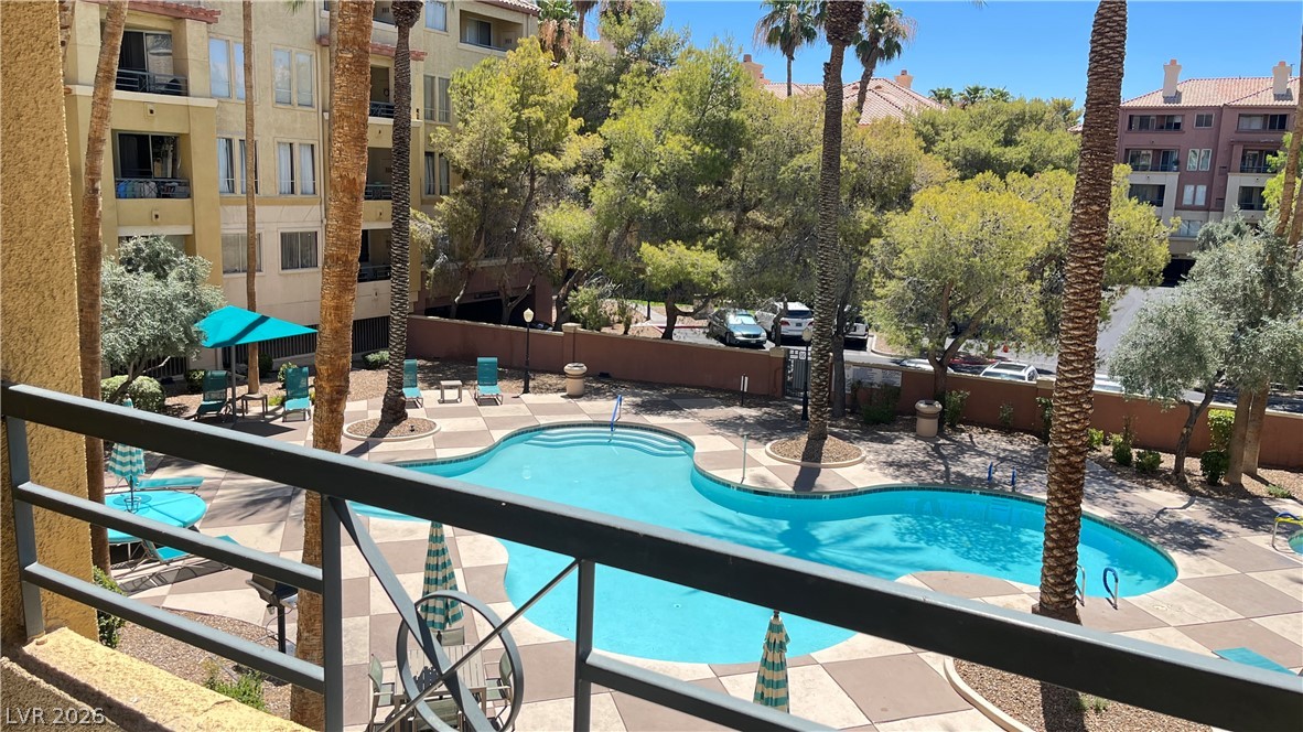 210 East Flamingo Road, Unit 205 Las Vegas, NV 89169 - Photo 1 of 17 A refreshing pool awaits, nestled amidst tropical landscaping and a charming paved deck.