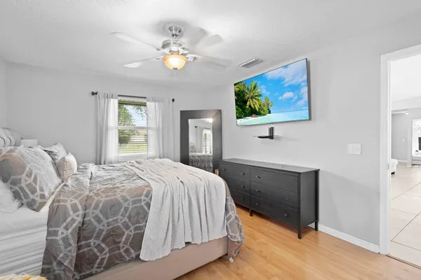 a bedroom with a bed and a chandelier