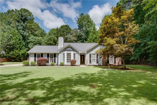 a front view of a house with a garden