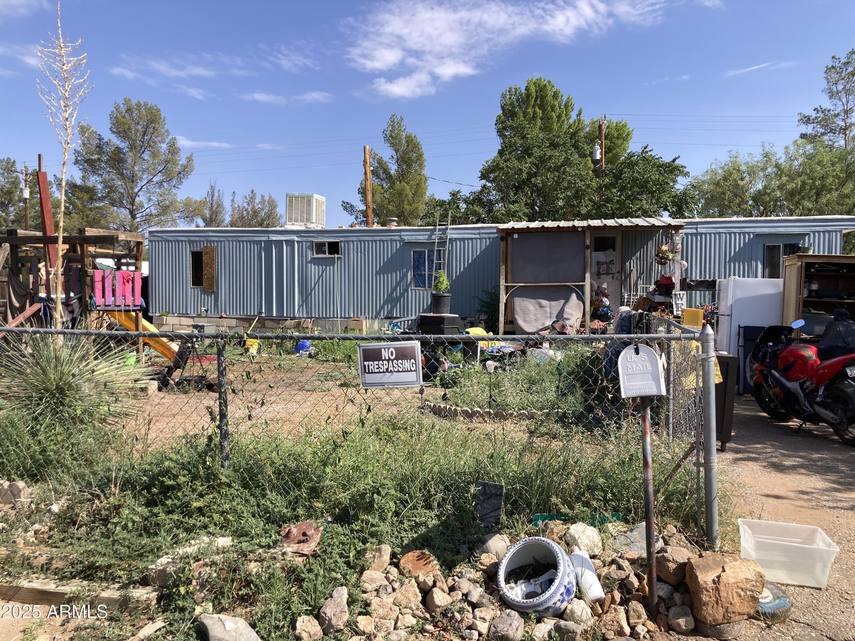 135 East Vía Papaya, Unit 56 Huachuca City, AZ 85616 - Photo 1 of 3 a backyard of a house with table and chairs