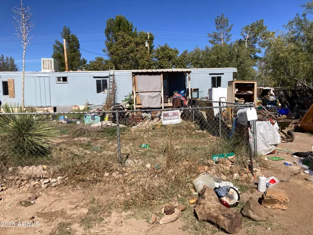 a view of a patio with table and chairs with wooden fence