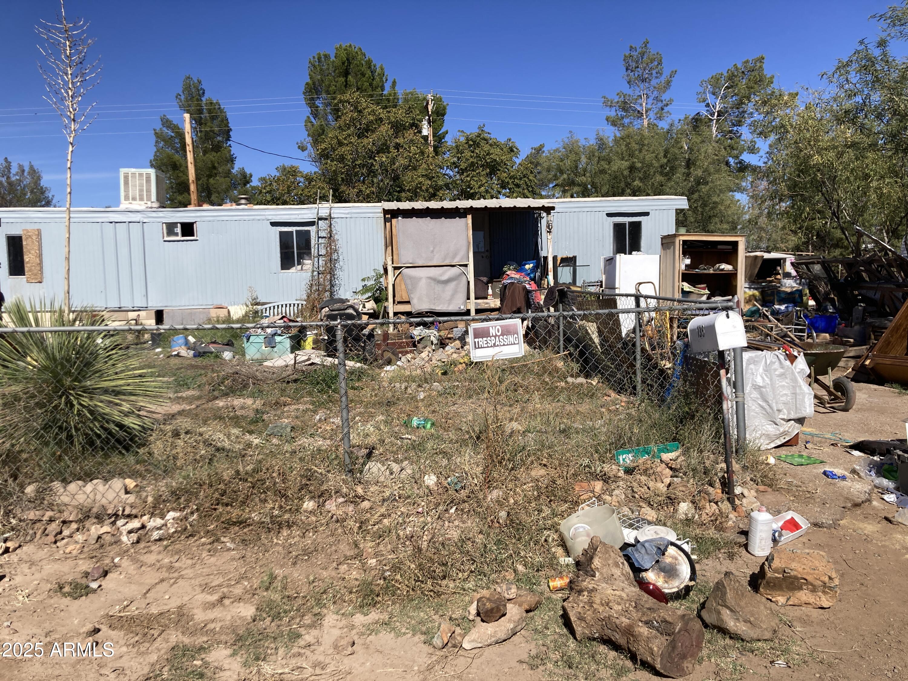 135 East Vía Papaya, Unit 56 Huachuca City, AZ 85616 - Photo 3 of 3 a view of a patio with table and chairs with wooden fence