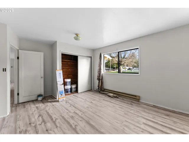 a view of empty room with wooden floor