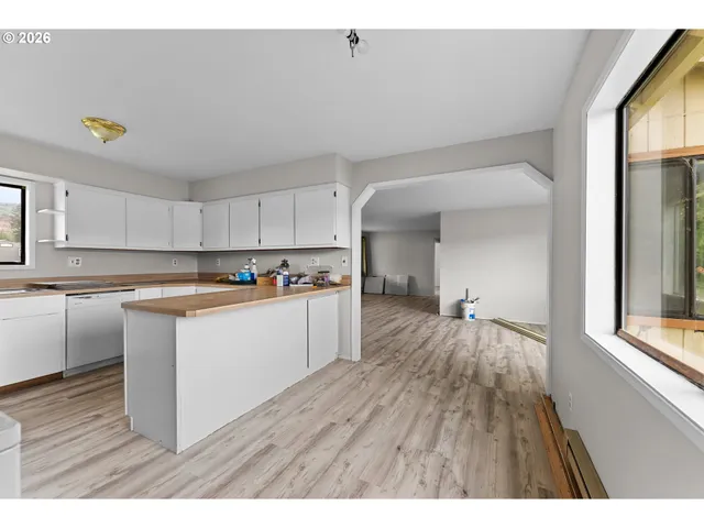 a kitchen with stainless steel appliances granite countertop a sink a stove and a refrigerator