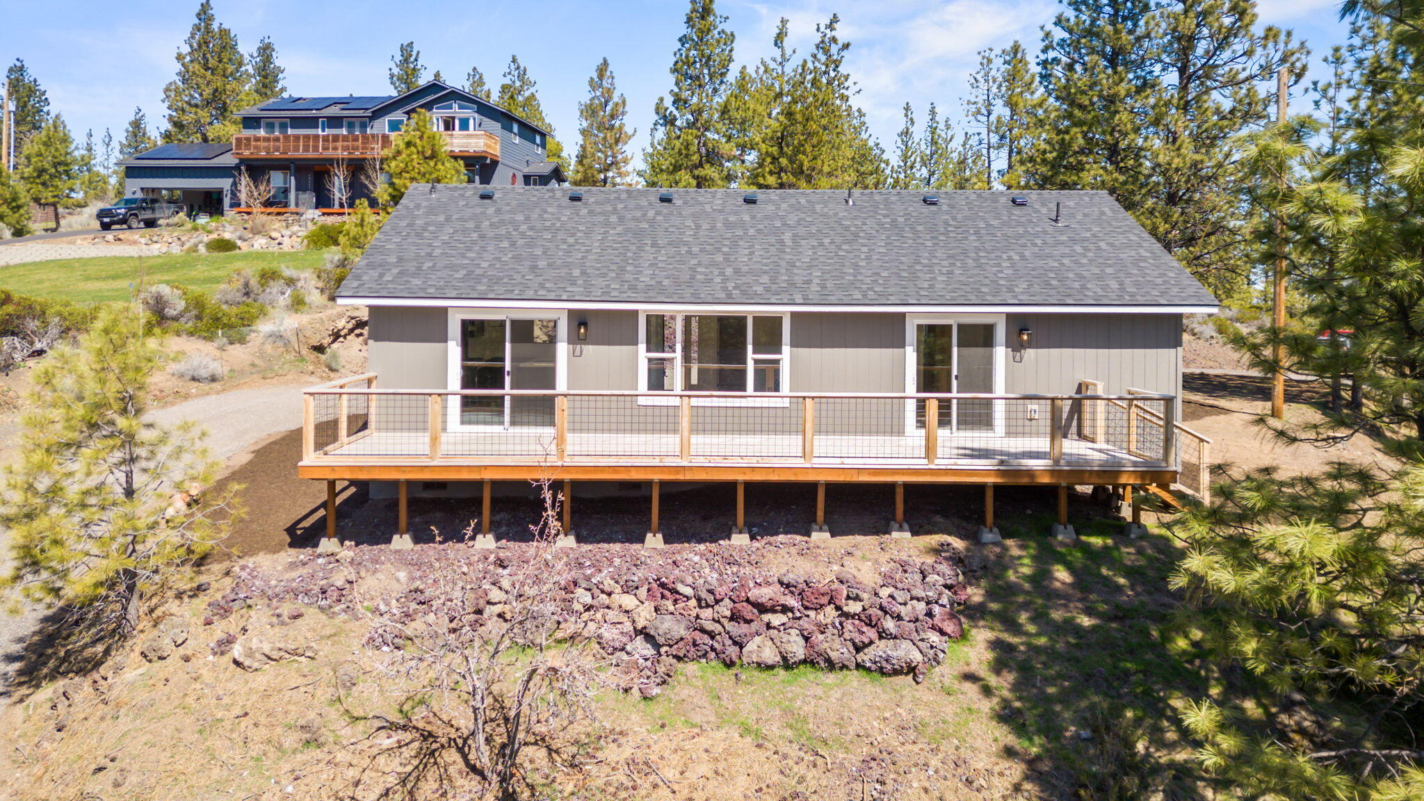 19126 Pumice Butte Road Bend, OR 97702 - Photo 35 of 40 a front view of a house with a yard table and chairs
