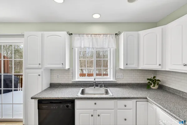 a kitchen with a sink a stove a refrigerator and cabinets
