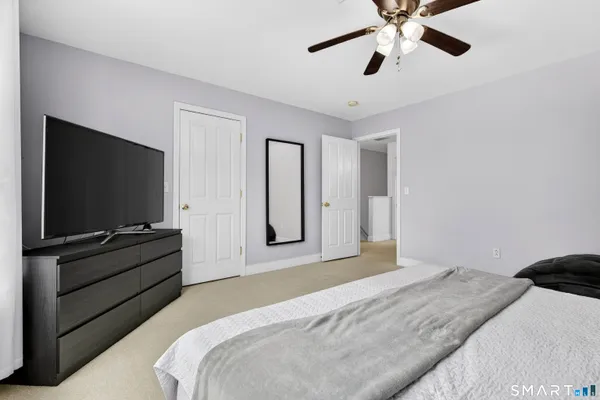 a bedroom with a large bed and a window