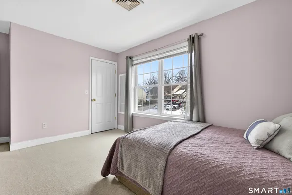 a spacious bedroom with a bed and a window