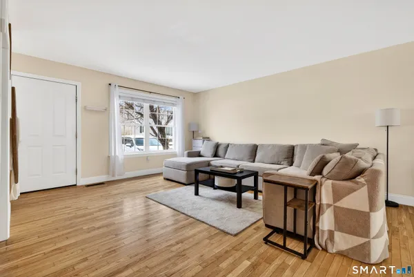 a living room with furniture and wooden floor