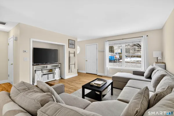 a living room with furniture and wooden floor