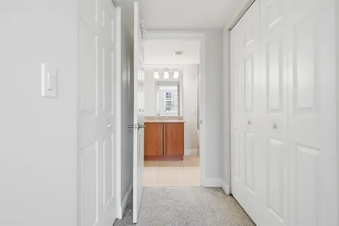 a view of a hallway with wooden floor and entryway