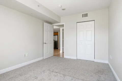 an empty room with closet area