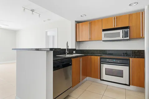 a kitchen with stainless steel appliances granite countertop a stove and a microwave