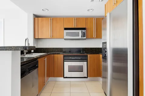 a kitchen with granite countertop a stove and a refrigerator