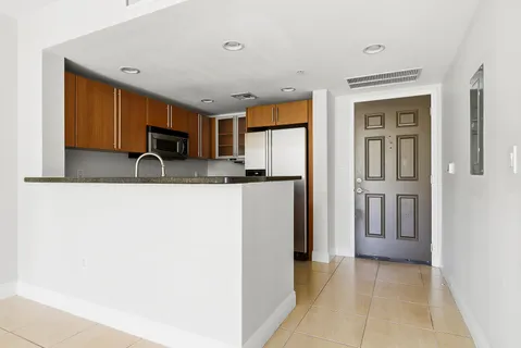 a kitchen with stainless steel appliances granite countertop a refrigerator and a sink