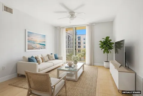 a living room with furniture and a potted plant