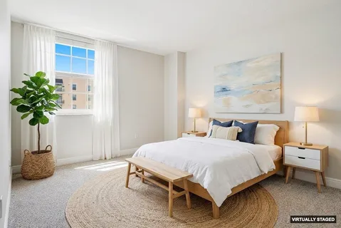 a bedroom with a bed and a potted plant