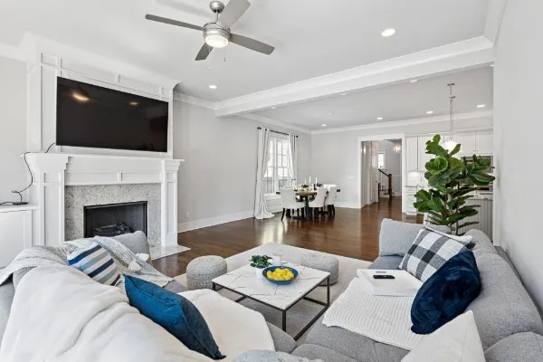 a dining room with stainless steel appliances kitchen island granite countertop a dining table chairs and granite counter tops