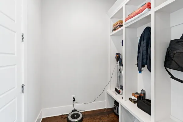a view of walk in closet with clothes and shoes
