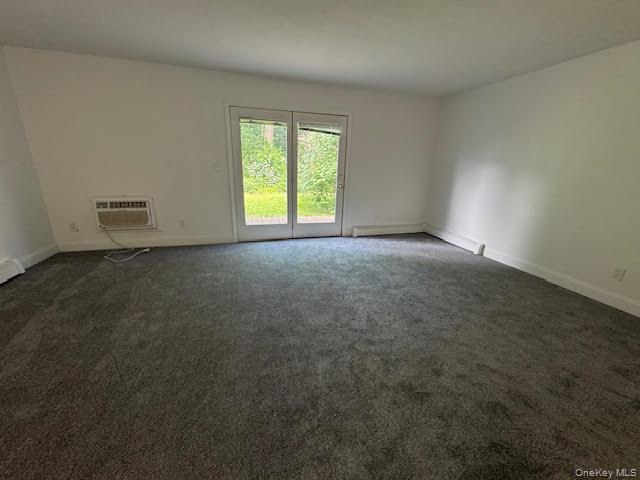 23 Brewster Road Cornwall, NY 12518 - Photo 13 of 39 Living room area with wall unit air condition and newer carpet flooring.