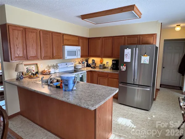 a kitchen with refrigerator and cabinets