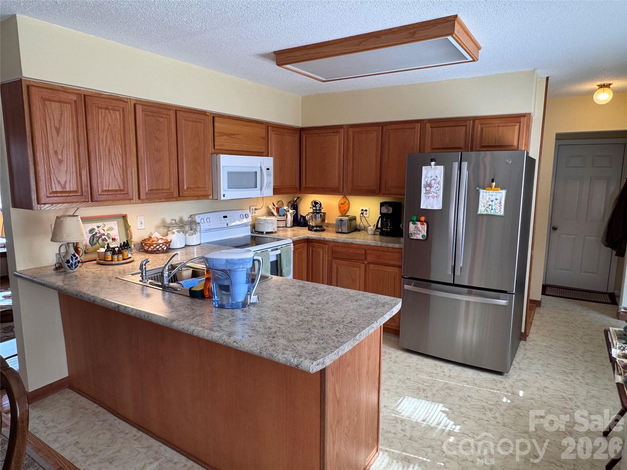 35 Azalea Drive Spruce Pine, NC 28777 - Photo 12 of 35 a kitchen with refrigerator and cabinets