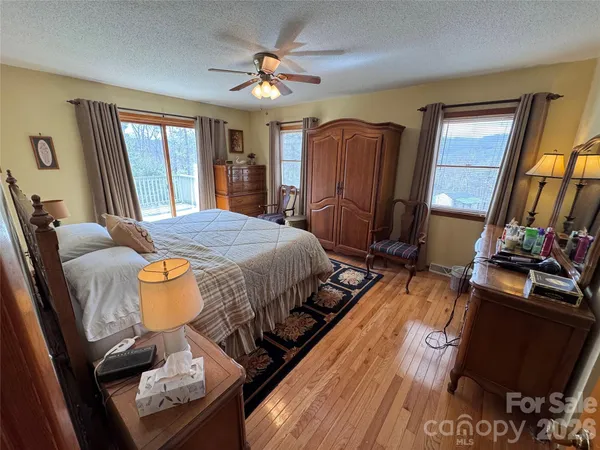 a bedroom with a bed dresser and a large mirror