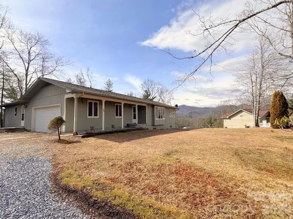 a view of a house with snow in the background