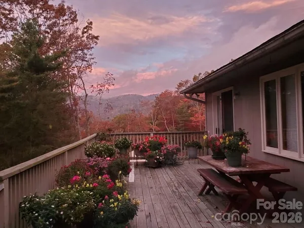 a view of a balcony with wooden floor and bench