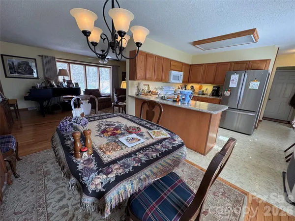 a living room with fireplace furniture and a chandelier