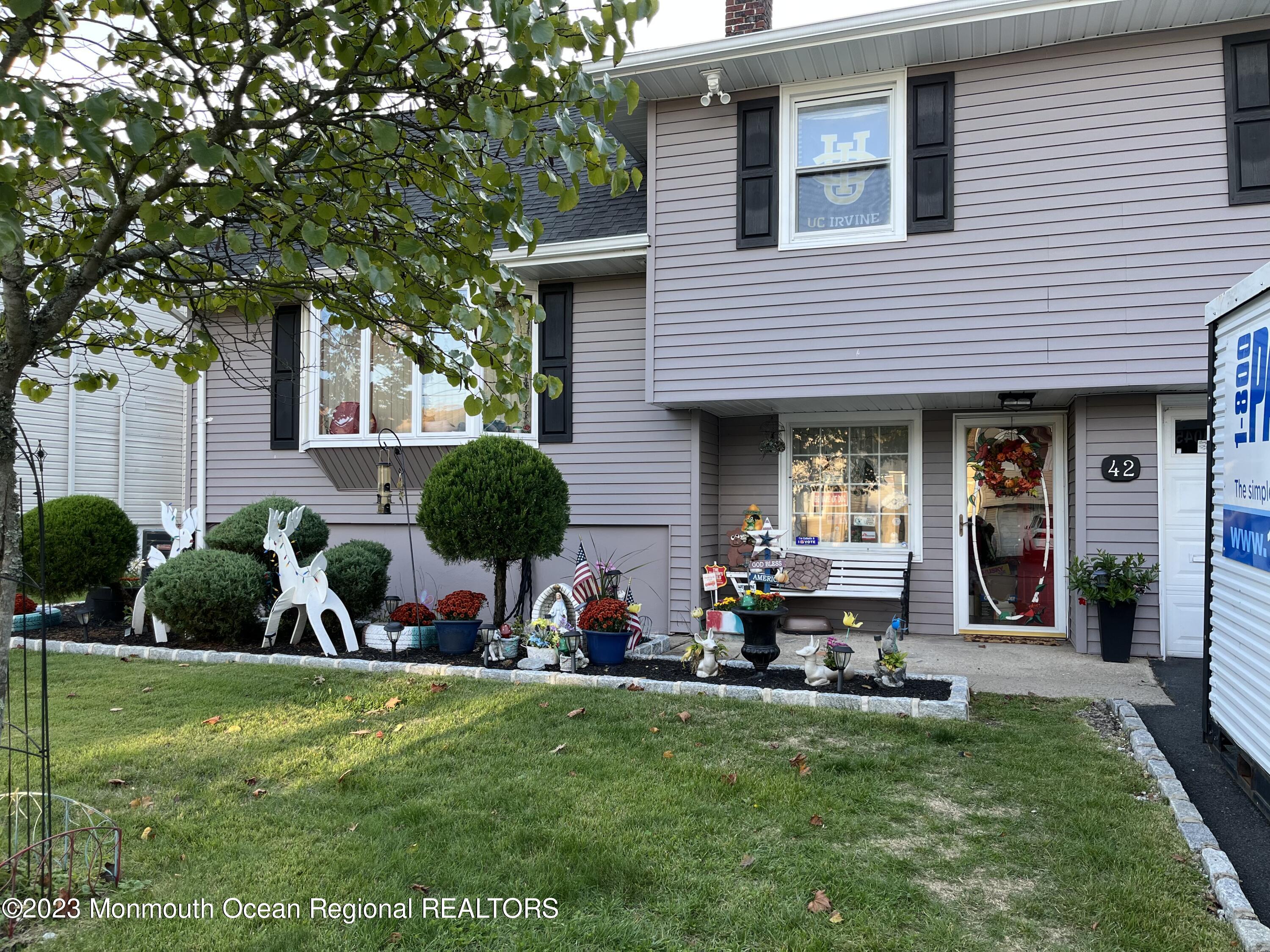 a view of a house with a yard porch and sitting area