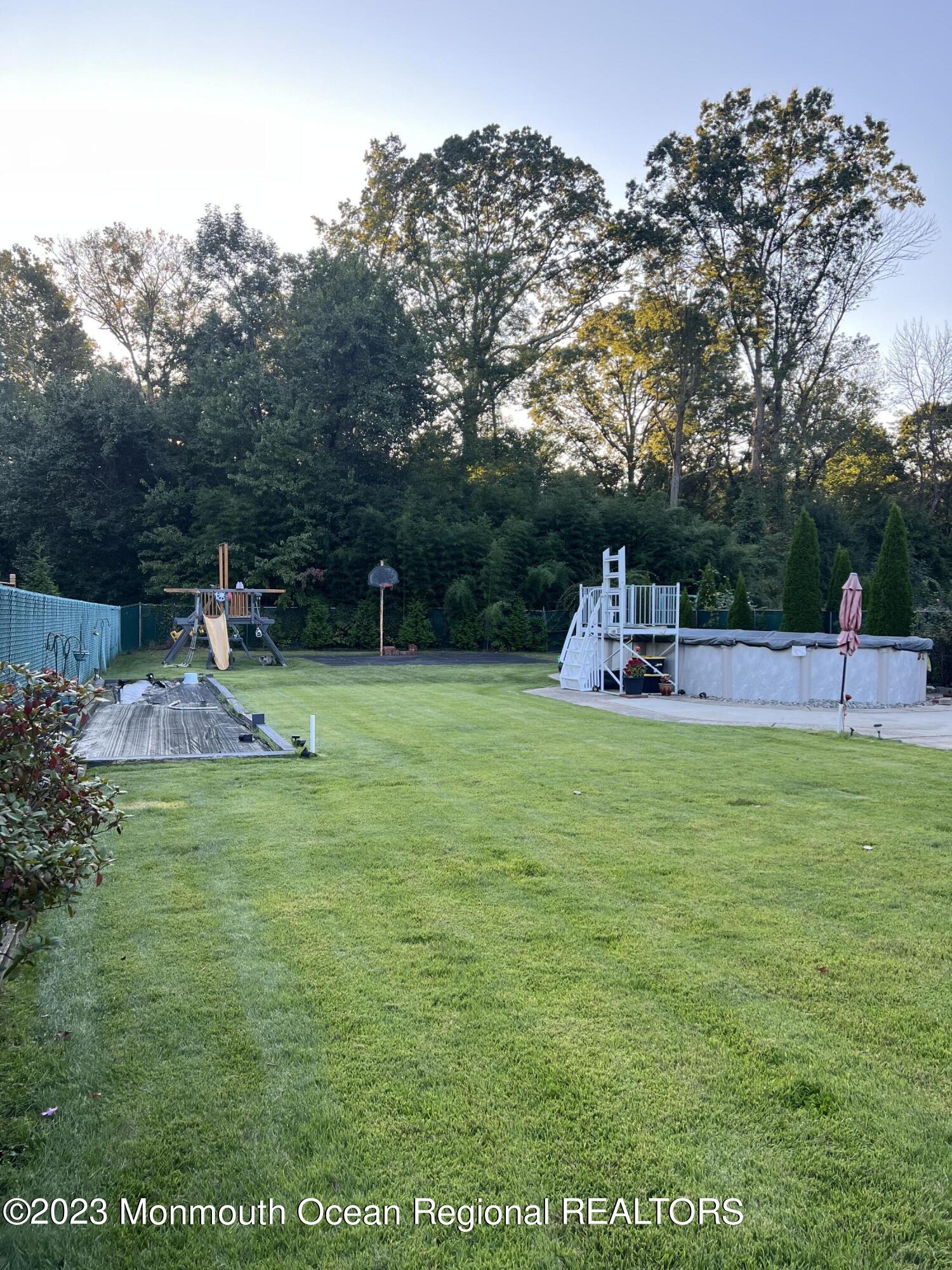 42 Epping Drive Kenilworth, NJ 07033 - Photo 19 of 22 a view of a park with swings and slides