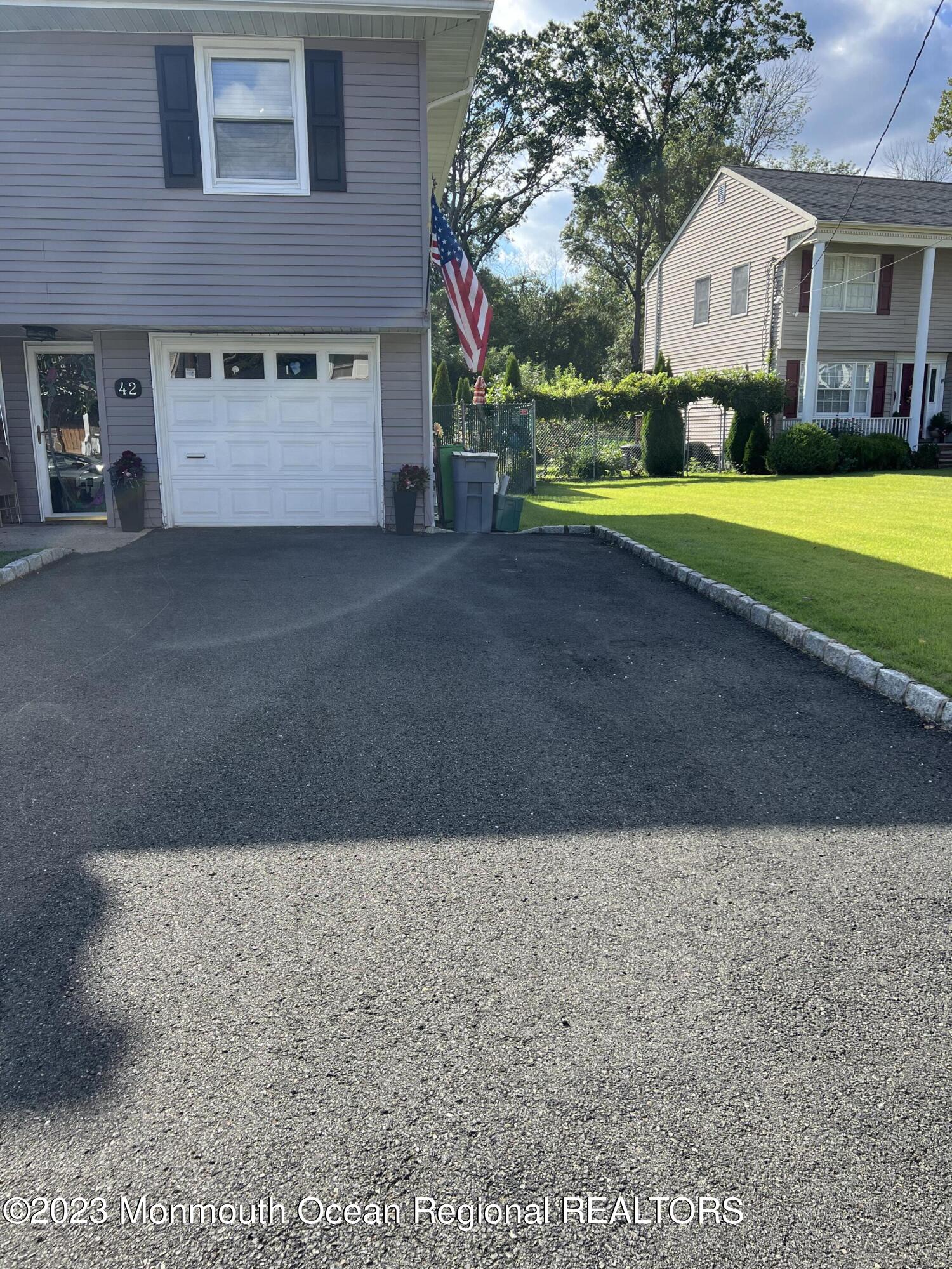 42 Epping Drive Kenilworth, NJ 07033 - Photo 2 of 22 a view of a house with a yard and garage